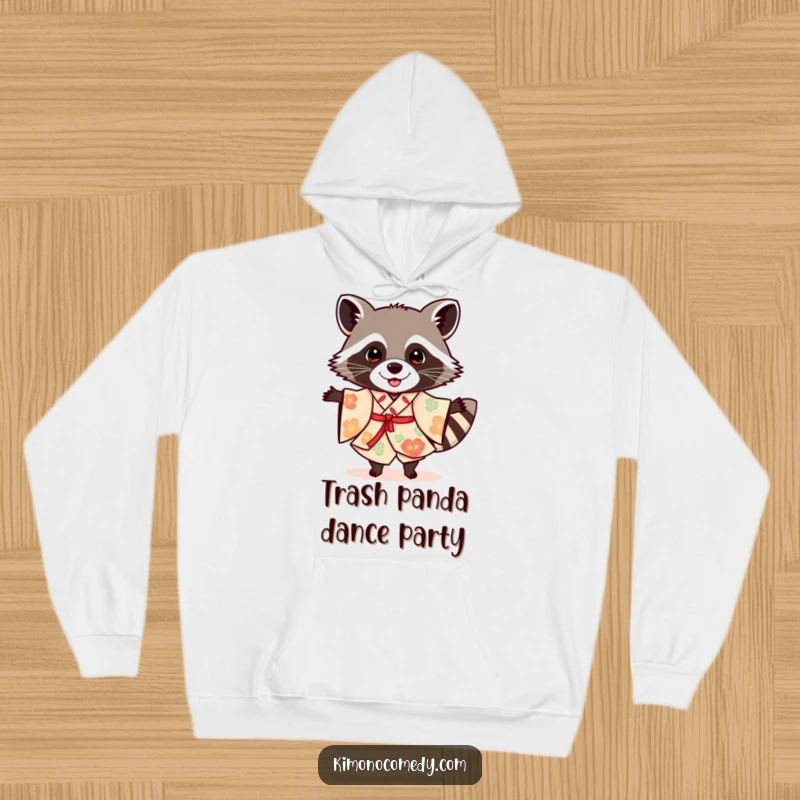 Funny raccoon in a festive kimono, dancing, featured on a cozy hoodie for humorous and warm wear.