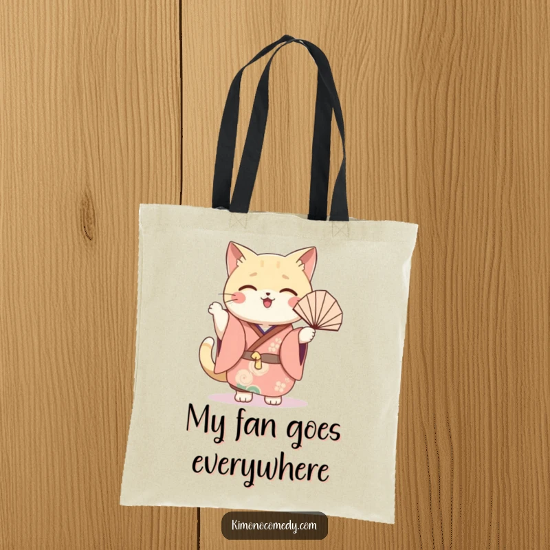 Funny cat fan tote bag with a kawaii cat in a festive kimono, joyfully waving a fan, perfect for stylish carrying.